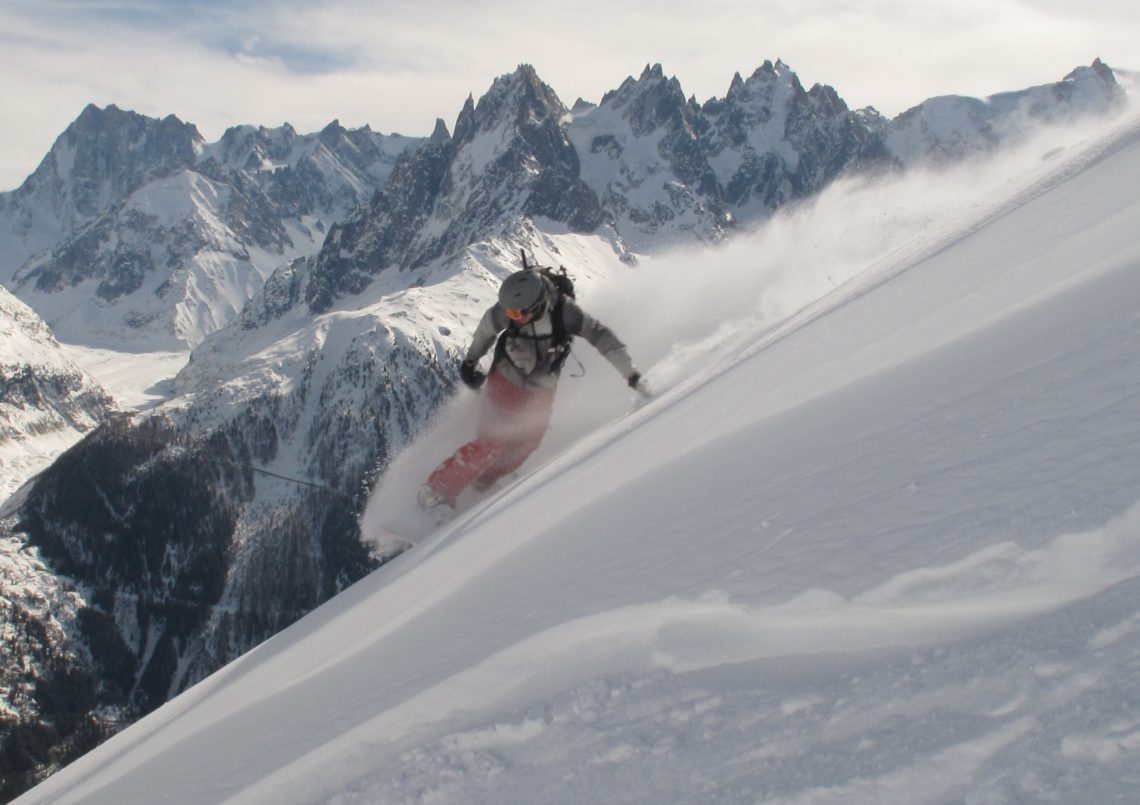 Snowboarding in front of the Aiguilles de Chamonix 